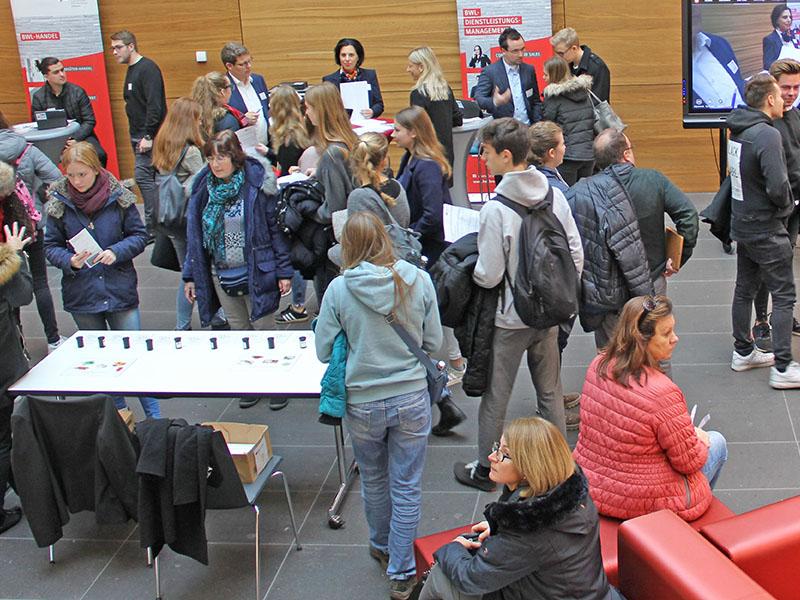 Das Foto zeigt viele Menschen und Informationsstände der DHBW auf dem Studieninformationstag.