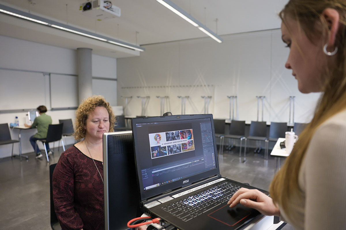 zwei Frauen sitzen an einem Laptop und benutzen einen stationären Eye-Tracker